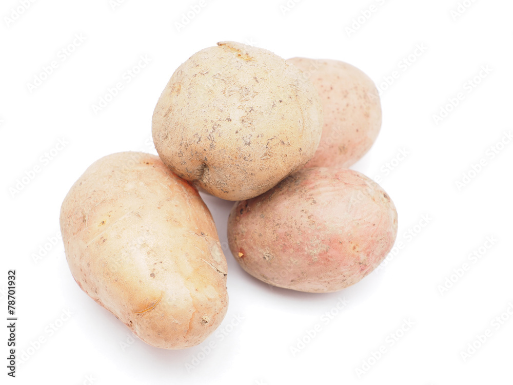 unpeeled potatoes on a white background unpeeled potatoes on a white background