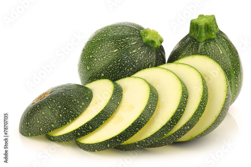 fresh Round Zucchini's and a cut one on a white background