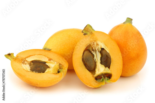 kumquats(Citrus japonica) and a cut one on a white background