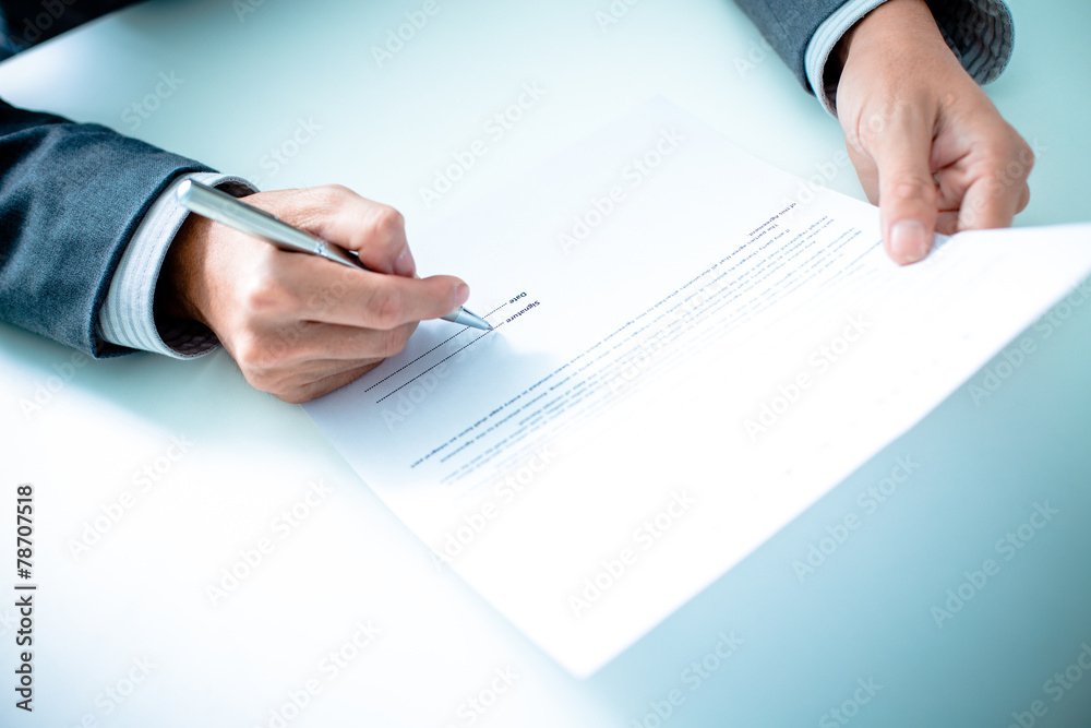 Business man signing a contract Business man signing a contract