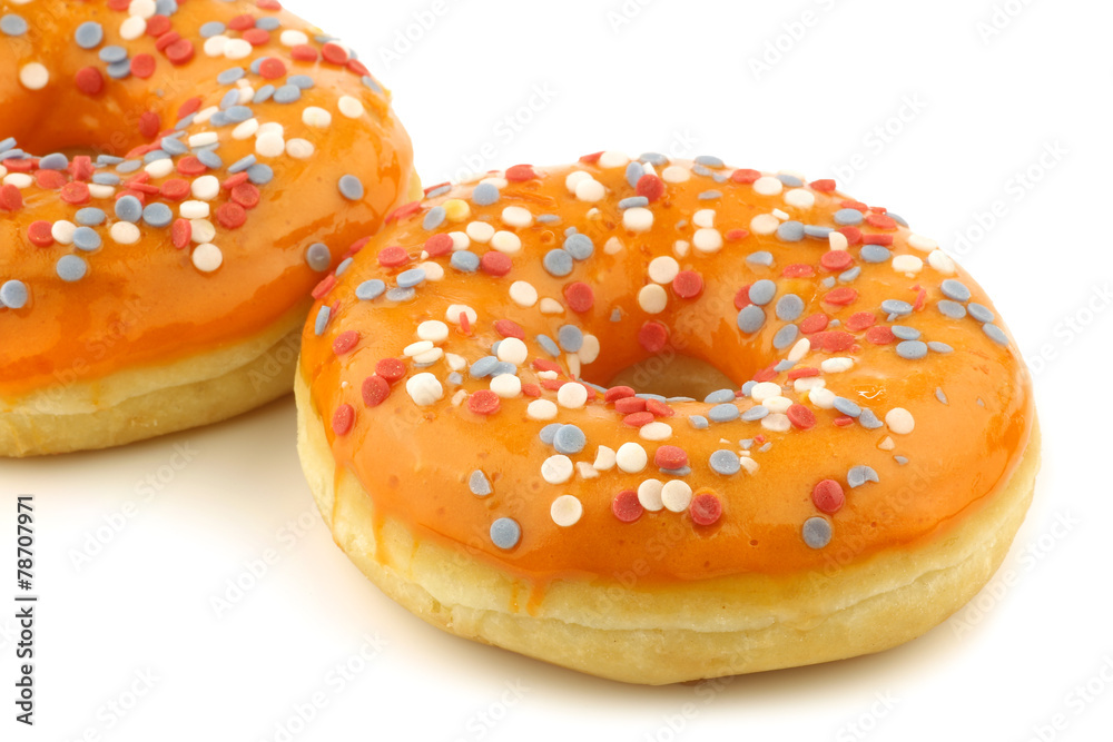 orange donut with red,white and blue sprinkles