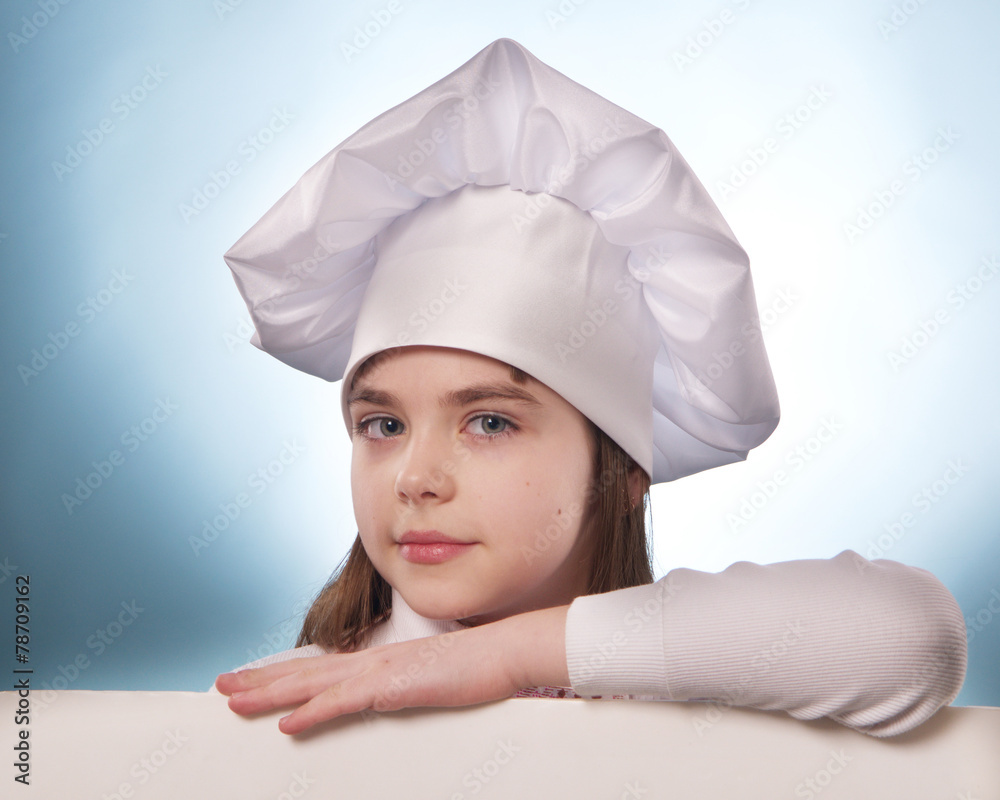 The girl with chef hat indicates with billboard isolated on the white and blue background The girl with chef hat indicates with billboard isolated on the white and blue background