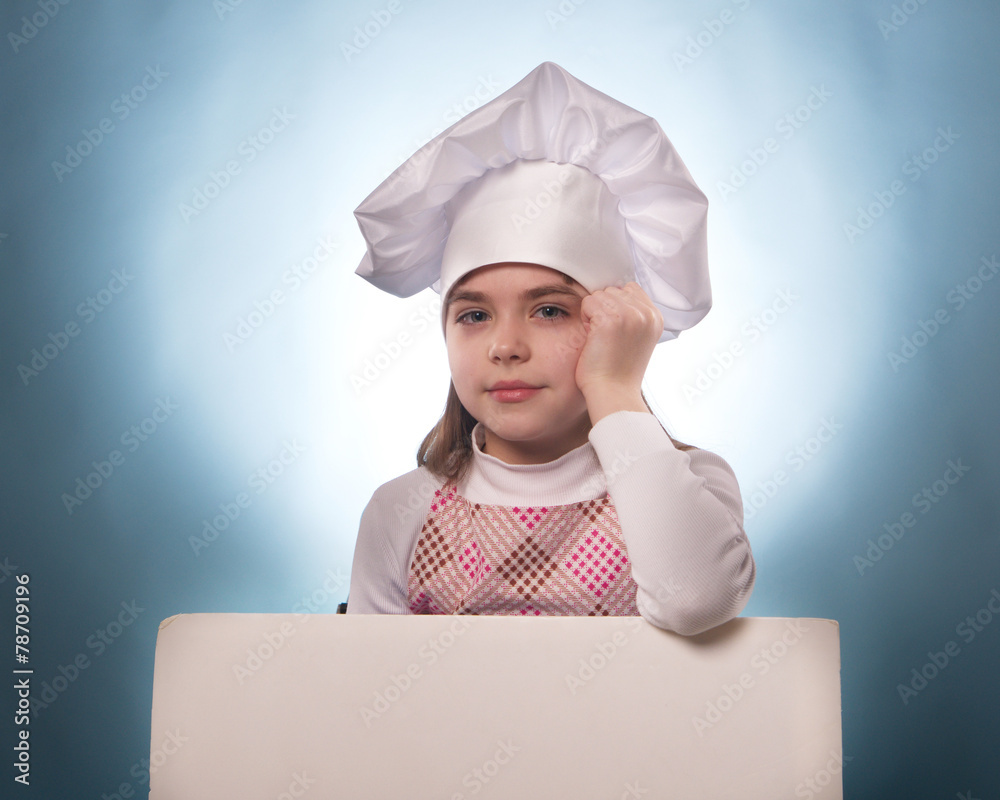  The girl with chef hat indicates with billboard  isolated on the white and blue background