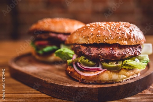 Fresh burger on wooden table.