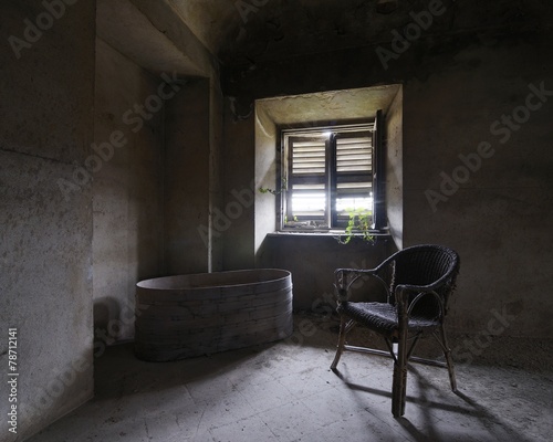 old abandoned room with chair and bathtub
