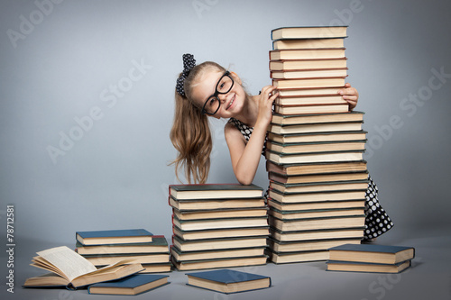 Girl with glasses reading a book