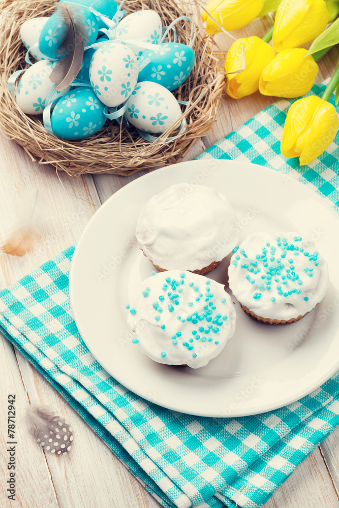 Easter with yellow tulips, colorful eggs and traditional cakes Easter with yellow tulips, colorful eggs and traditional cakes