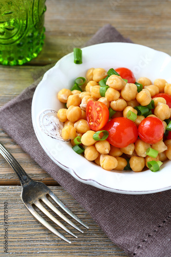 Salad with chickpeas and tomatoes on a bowl