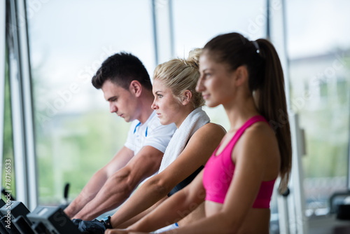friends exercising on a treadmill at the bright modern gym