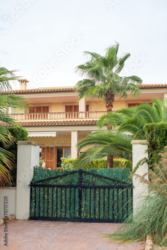 Portrait of tropical house with fence.