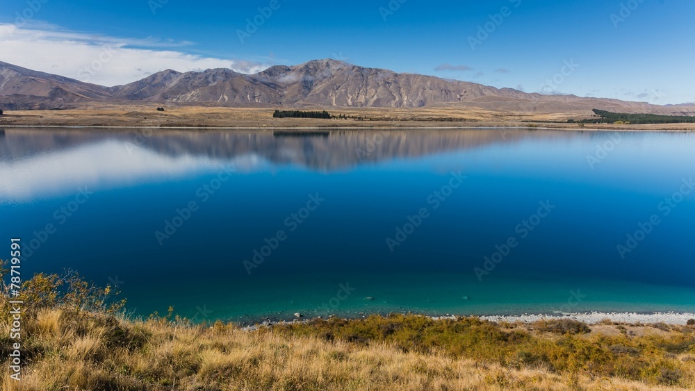 mountains reflecting in lake tekapo