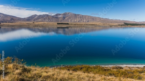 mountains reflecting in lake tekapo