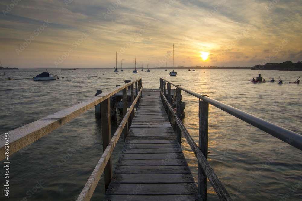 Sunset on jetty at beach at Rockley Park