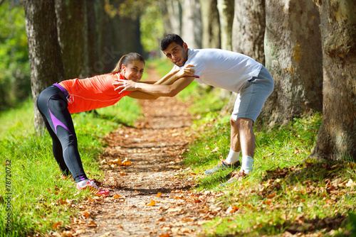 Fototapeta Naklejka Na Ścianę i Meble -  Young couple jogging in park at morning. Health and fitness.