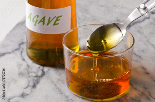 Agave syrup pouring on a glass.