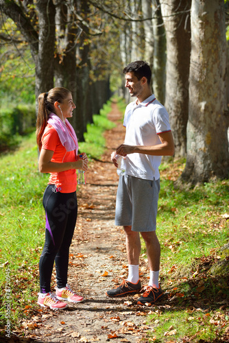Fototapeta Naklejka Na Ścianę i Meble -  Young couple jogging in park at morning. Health and fitness.