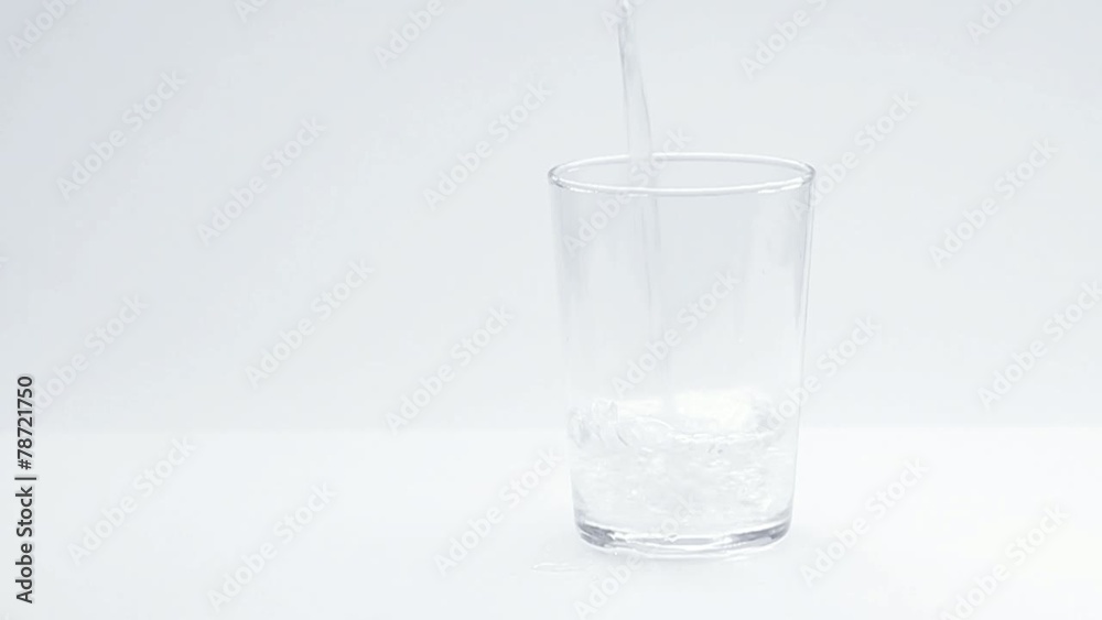 Water pour into a glass, white background Water pour into a glass, white background