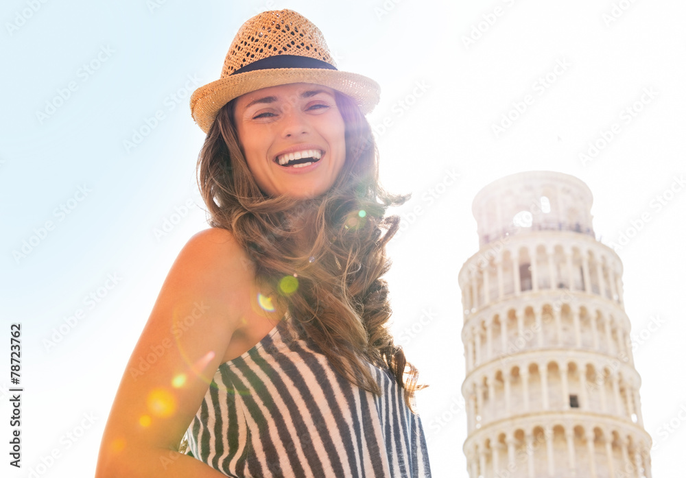 Portrait of smiling woman in front of leaning tower of pisa