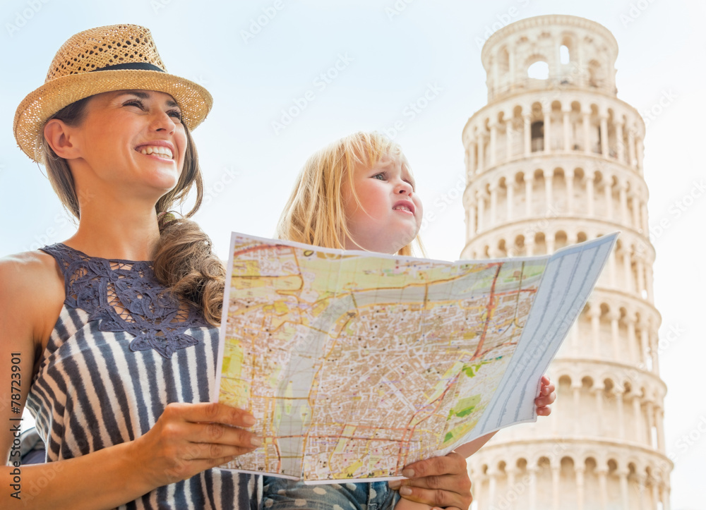 Fototapeta premium Happy mother and baby girl with map in Pisa