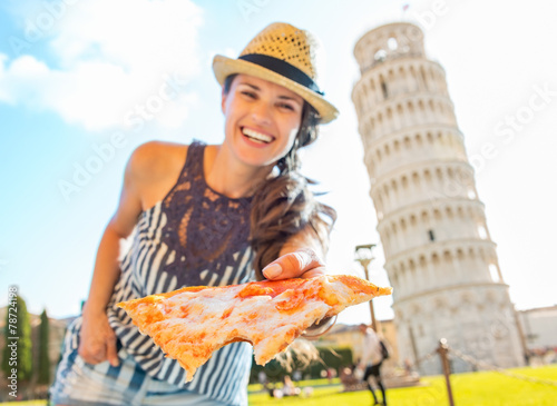 Obraz na plátne Smiling woman giving pizza in front of leaning tower of pisa