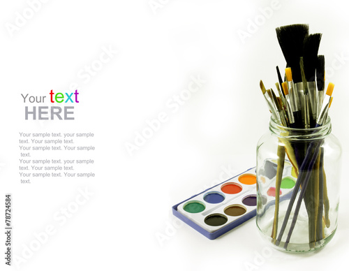Watercolors and brushes in glass jar