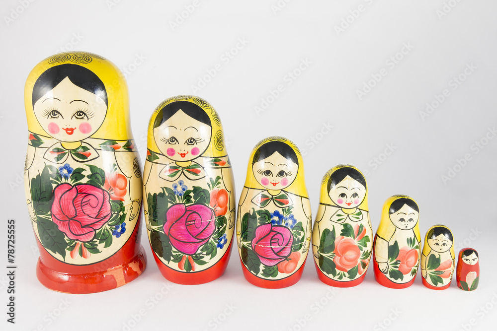 Seven traditional Russian nesting dolls descending in a row