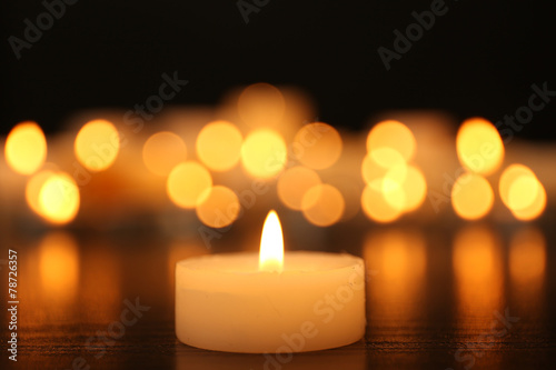 Burning candles on dark background