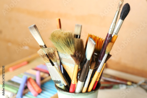Paintbrushes with colorful chalk pastels in box