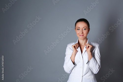 Portrait of young woman on grey background