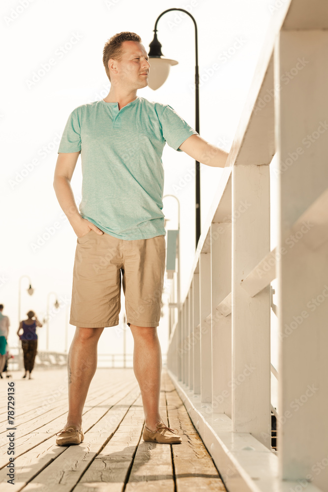 Fashion portrait of handsome man on pier