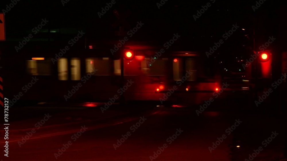 A car pulls out of the train crossing after the train passes