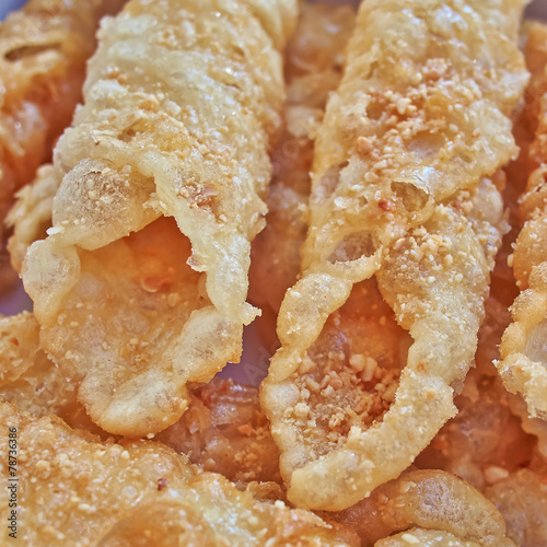 Diples, traditional Greek sweet fries with honey syrup and nuts photo