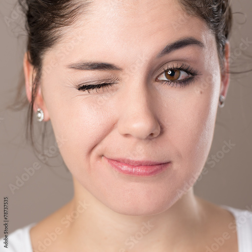 Portrait of a young brunette woman making faces photo