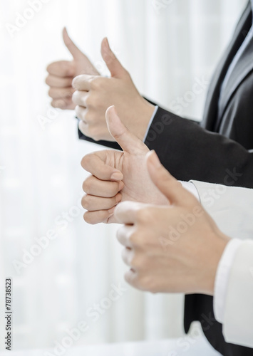 Row of human hands showing thumb up