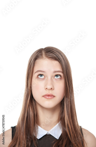 Young teenage girl looking up on something isolated