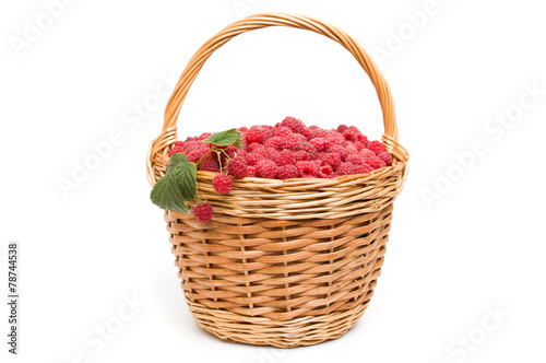 fresh red raspberries in the basket isolated on white background