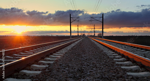 Railroad at sunset with sun and lines