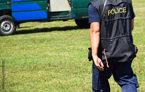 Police officer goes towards the patrol car