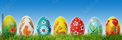 Hand painted Easter eggs on grass. Panorama, banner.