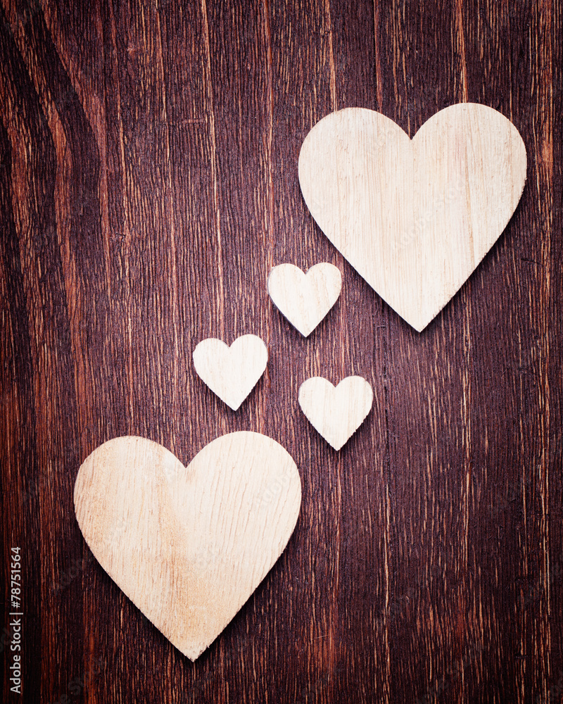 Big and small wooden hearts placed nicely on a vintage wood back Stock  Photo