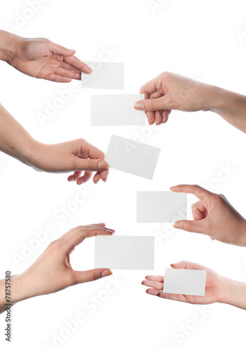 Set of hands holding empty business cards on white