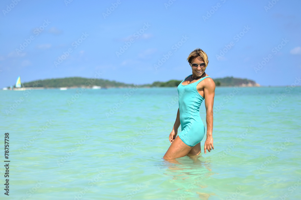 Happy young woman posing by the sea