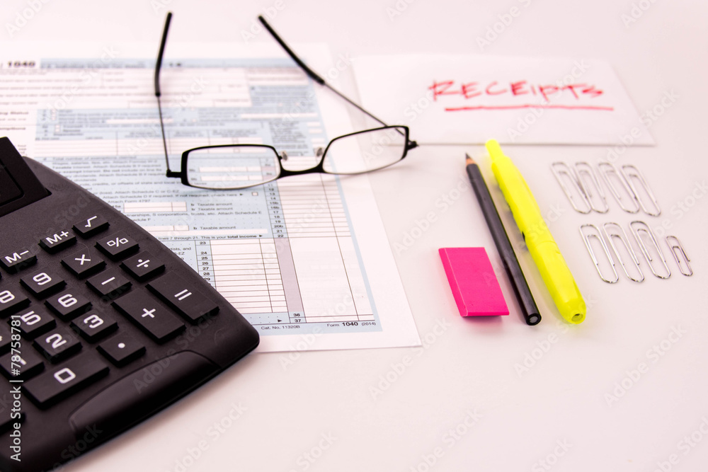 Tax preparation supplies, reading glasses and tax forms Tax preparation supplies, reading glasses and tax forms