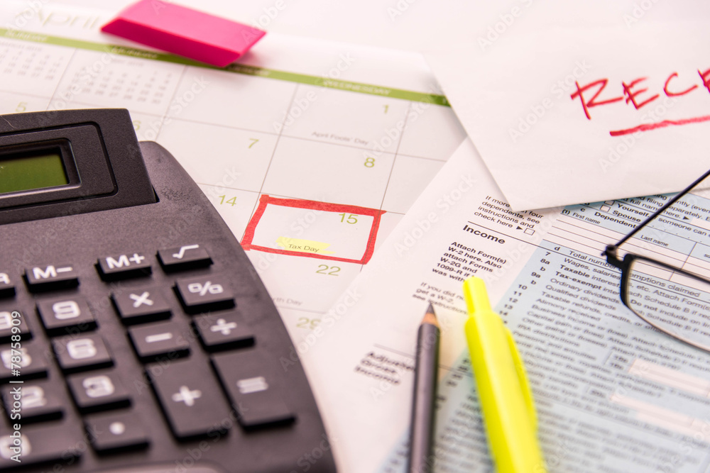 Tax preparation supplies, reading glasses and tax forms Tax preparation supplies, reading glasses and tax forms