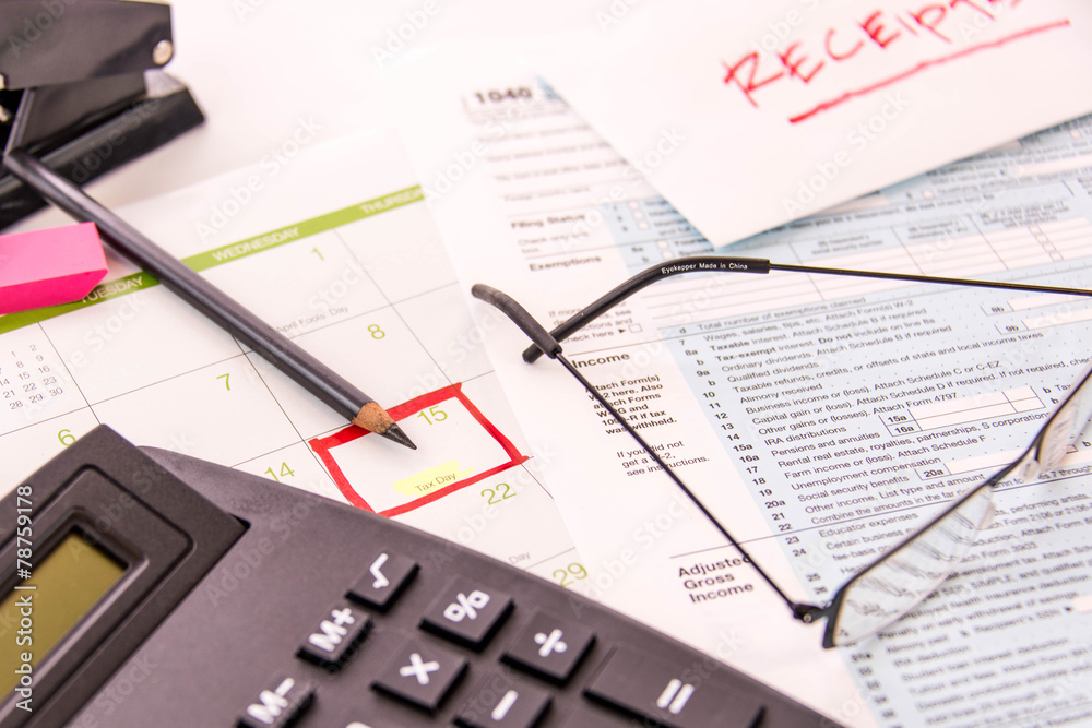 Tax preparation supplies, reading glasses and tax forms Tax preparation supplies, reading glasses and tax forms