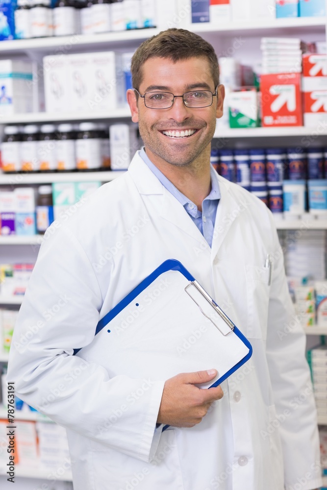 Happy pharmacist holding clipboard Happy pharmacist holding clipboard