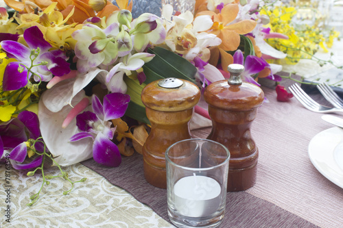Jars, salt and pepper on the table Dinner with flowers.