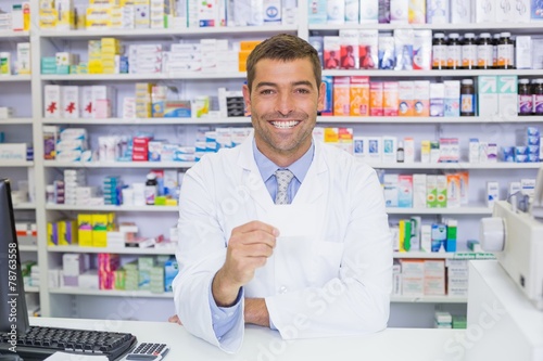 Handsome pharmacist holding paper