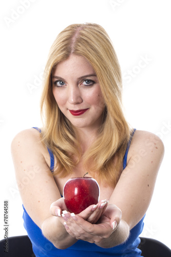 Model Released. Attractive Young Woman Holding a Red Apple