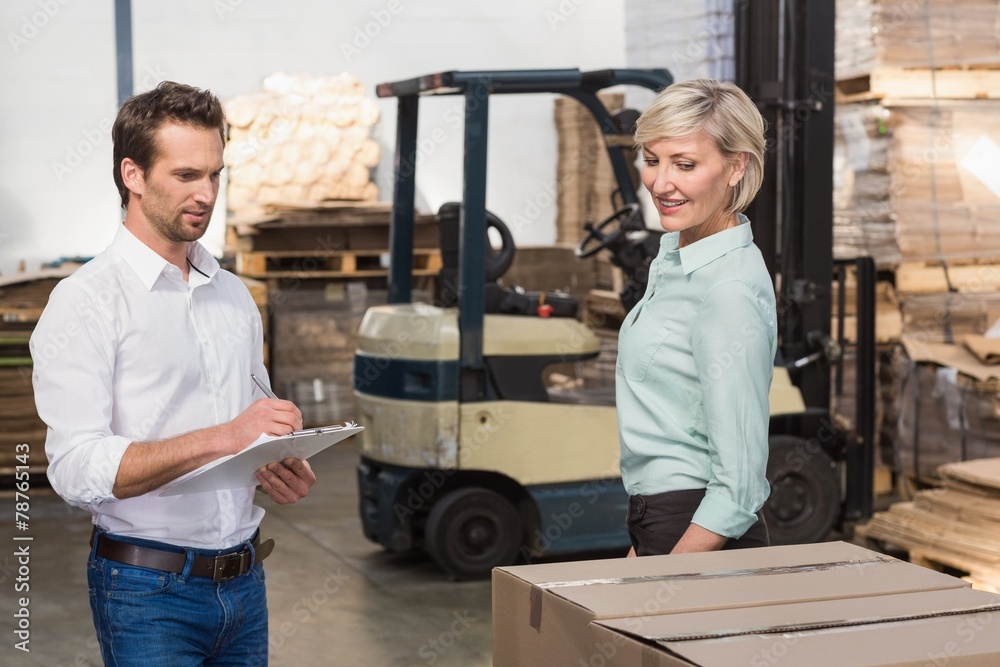 Two warehouse managers checking inventory